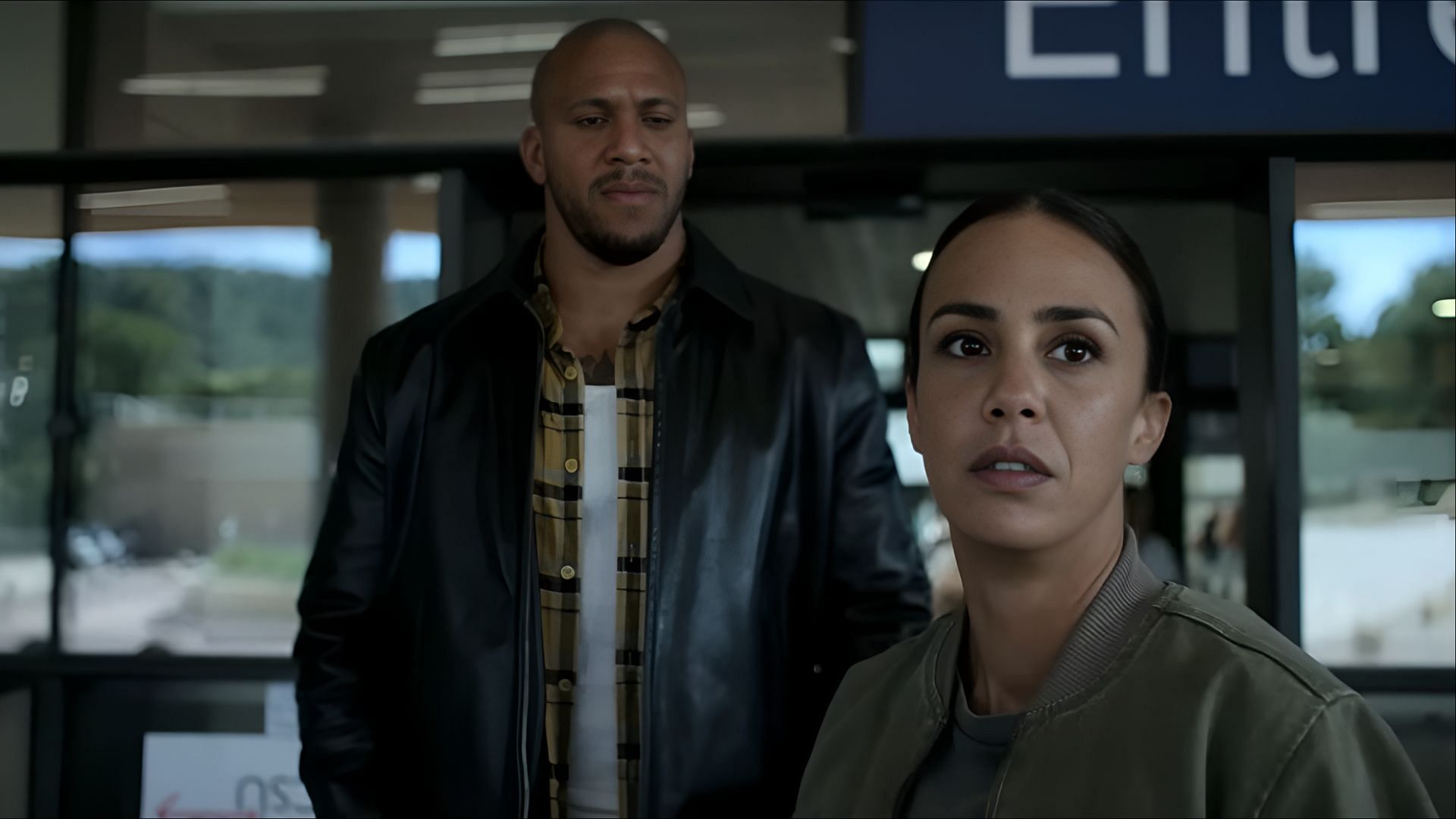 Ciryl Gane as Bastien and Alice Belaïdi as Kenza outside a public facility in K.O. (2025) (Image via Netflix)